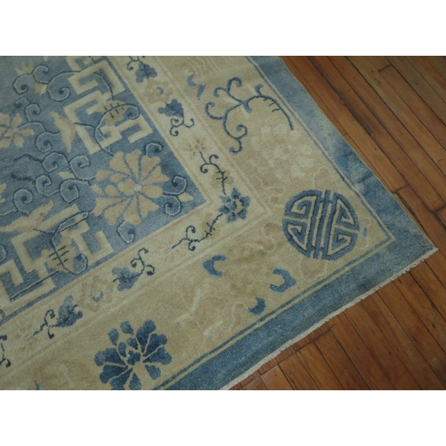 An early 20th century oversize size one of a kind Chinese rug in various predominant light blues and creams. The wool and...