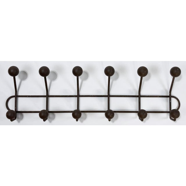 Industrial style vintage twelve (12) ball wall hook. Solid iron structure with brown painted wood balls to cap hooks....