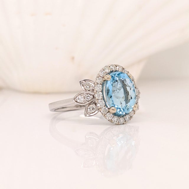 A blue aquamarine in 14k white gold with all natural earth mined diamond accents. A statement ring design perfect for an...