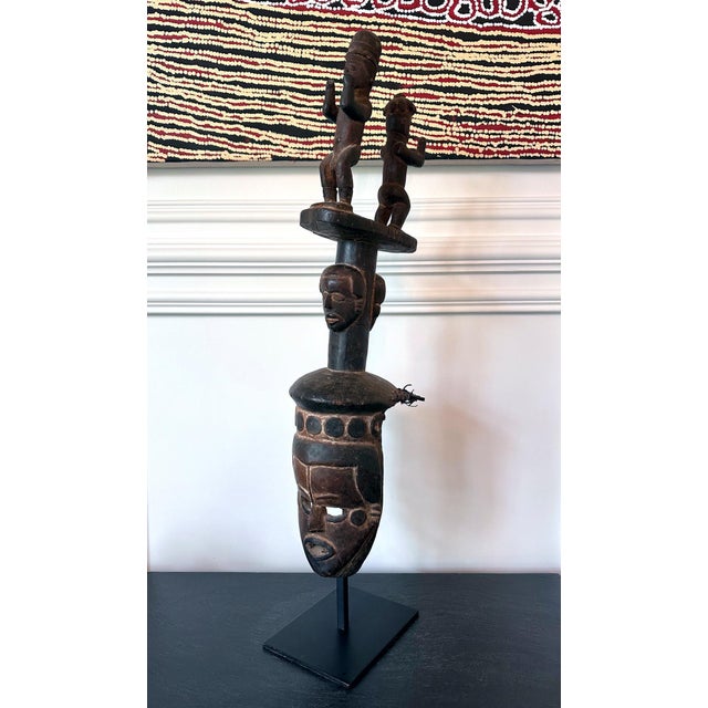 A tall Ibibio wood mask from Nigeria, Africa, circa 20th century. The head mask was carved in with a frontal face with...