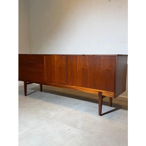 Classic mid-century modern sideboard produced by Nathan Furniture , crafted in beautifully grained teak wood and standing...