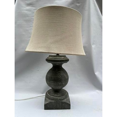 A single vintage Pottery Barn turned wood baluster form table lamp featuring a white washed green painted finish and a...