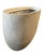 A monumental oval-form planter. Standing at an impressive 31 inches tall, this piece combines the substantial, industrial...
