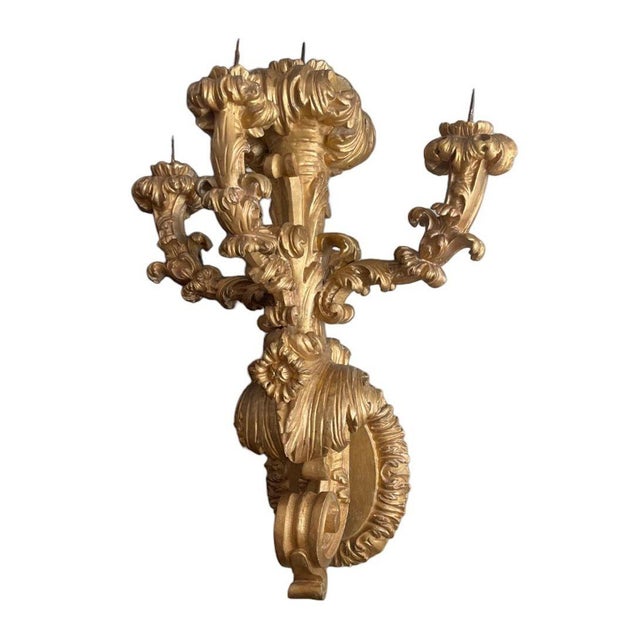 A rare and impressive pair of early 19th century Italian wall-mounted candelabras, masterfully carved in the Baroque taste...