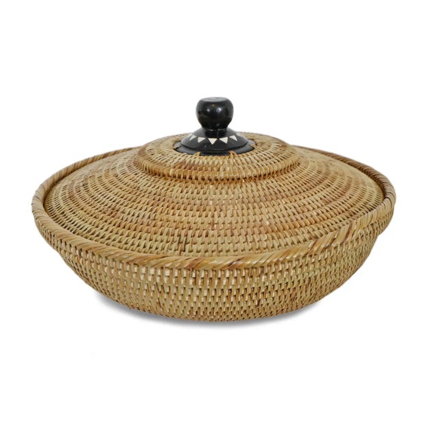 Masterfully hand woven vintage rattan Kenta bowl with painted wooden lid. Open up to see beautiful embroidered fabrics of...