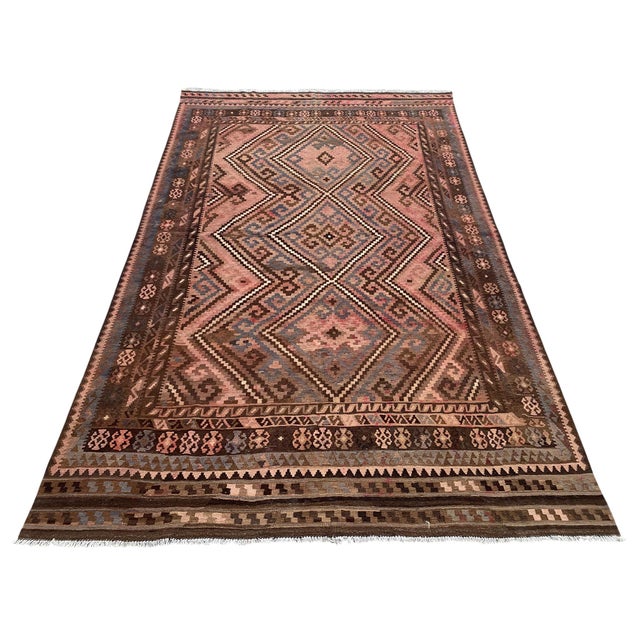 A large vintage handwoven kilim from Maimana in northern Afghanistan, in a softened palette of rose, slate blue, chocolate...