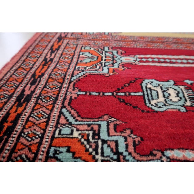 An exceptional Vintage Uzbek Bukhara Multi-Niche Prayer Runner hand-knotted by skilled weavers in Uzbekistan during the...