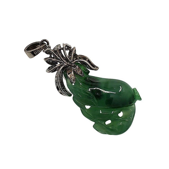 Vintage carved jade & diamond 18KW pendant, circa 1940. This vintage pendant features a carved green jade set in 18 karat...