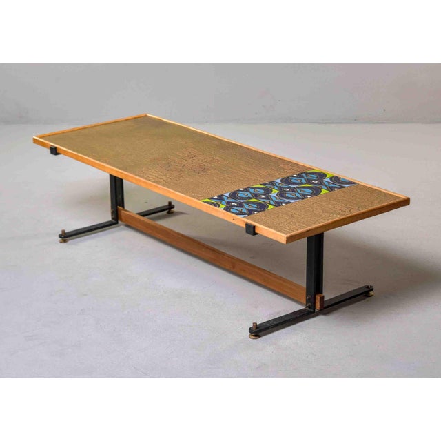 This low rectangular cocktail table features a top combining two surface treatments: a large craquelure field in gold and...