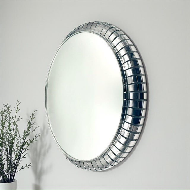 Striking Space Age illuminated wall mirror produced in Italy during the 1970s. The mirror is framed by a deeply sculpted...