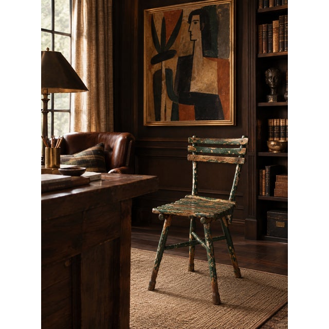 An exceptional early 20th-century Adirondack chair with a sculptural branch frame, slatted seat, and tall open back. Deep...