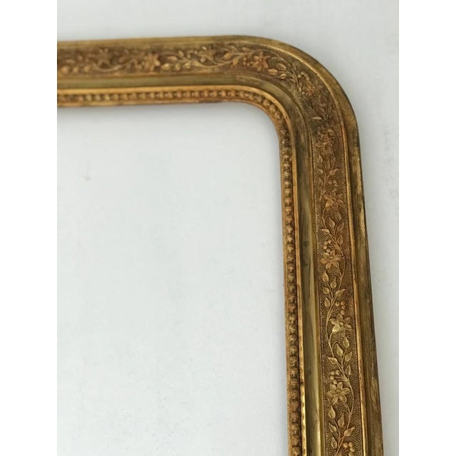 A substantial antique Louis Philippe style picture frame dating from the 19th century. Crafted in carved wood with gesso...