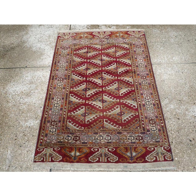 A vintage Central Asian Tekke throw rug handmade during the Mid-20th century. Measures: 2' 9" x 3' 10"