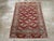 A vintage Central Asian Tekke throw rug handmade during the Mid-20th century. Measures: 2' 9" x 3' 10"