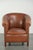 This beautiful English club chair is made of cowhide leather and, thanks in part to its decorative studs, features a...