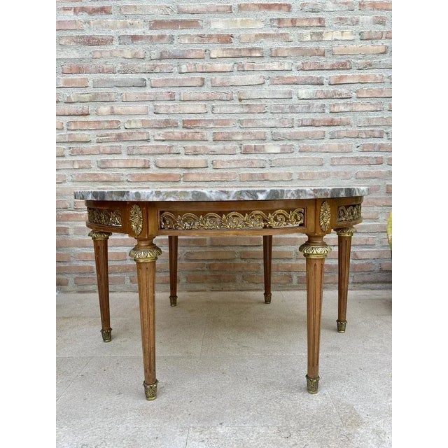 20th century louis xvi style with bronze and round marble french oak wood table. solid oak with partial veneer and finely...