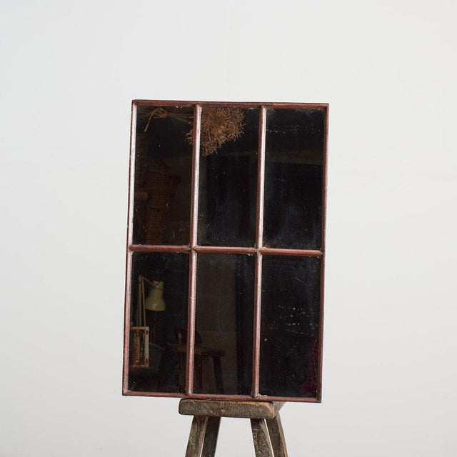 An original cast metal factory window which has been re-glazed ready to use as a mirror. The mirror frame is cast metal...