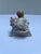 A single antique Victorian porcelain figurine depicting “tug of war” with baby and dog.