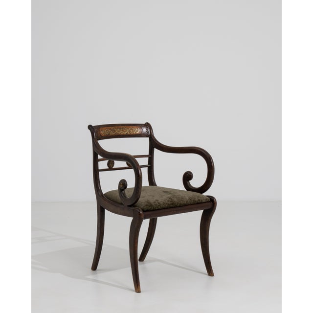 A distinguished example of British Regency craftsmanship, this sabre-leg armchair embodies the early nineteenth century's...