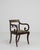 A distinguished example of British Regency craftsmanship, this sabre-leg armchair embodies the early nineteenth century's...