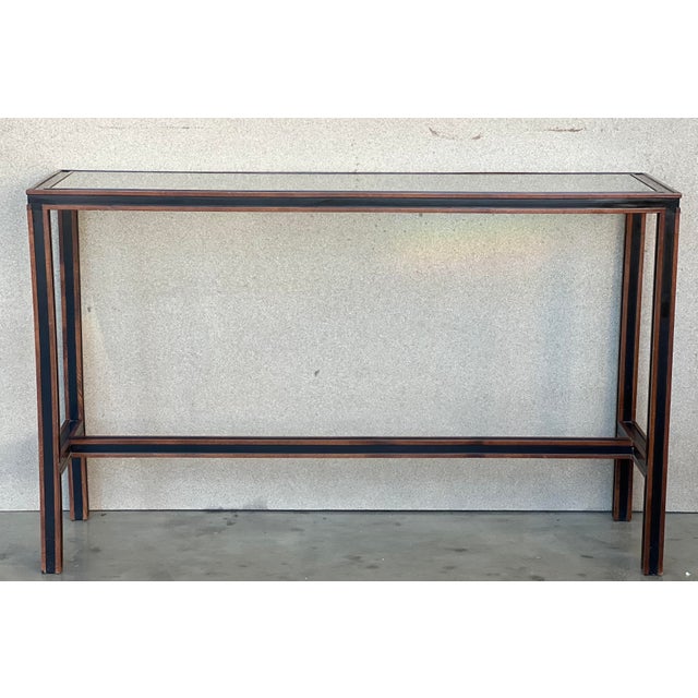 Console produced in Italy in the 70s. The console was made with a 4-legged structure in wood and ebonized wood with a...