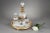 Service known as "glass of water" in white opaline with black and gold decoration with flowery borders. It is composed of...