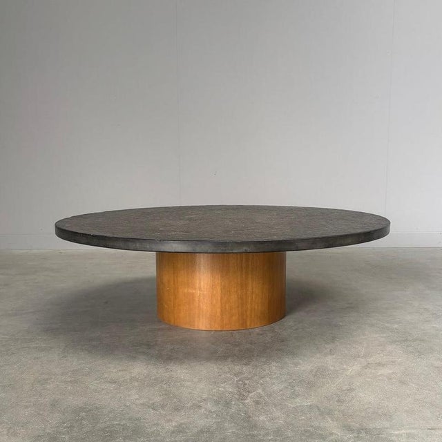 Remarks: Mid century round coffee table with slate stone top and wooden base, Germany 1970s. Table is in very good...