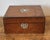 This exquisite Victorian-era traveling writing box is a masterclass in late 19th-century artisanal luxury. The exterior is...