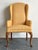 This vintage wingback chair is a masterful blend of classic Queen Anne silhouettes and organic, tactile materiality....