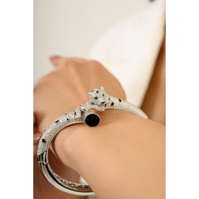 This magnificent Panther Wrap Bangle Bracelet features round brilliant cut diamonds totaling 6.51 carats, set in rich 14k...