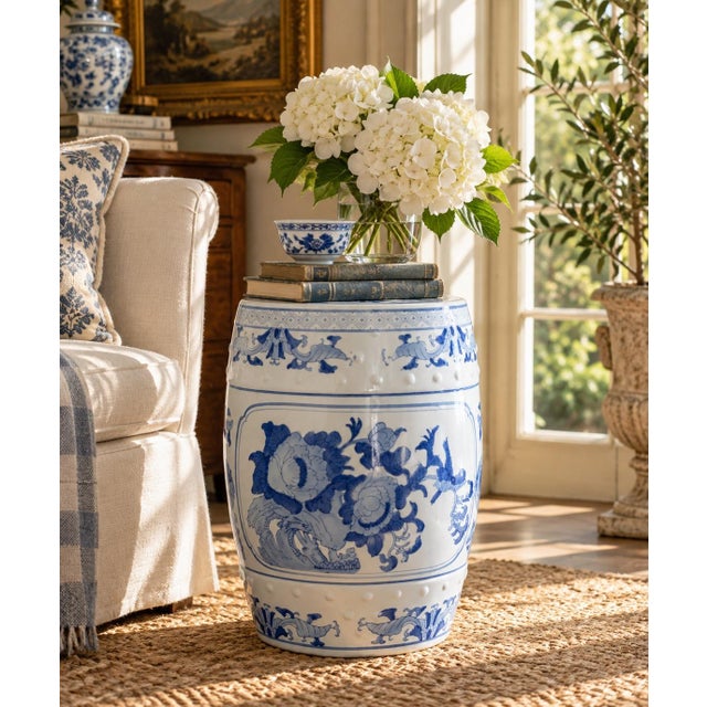 A classic blue and white porcelain garden stool, decorated with traditional Chinese motifs and stylized floral elements....