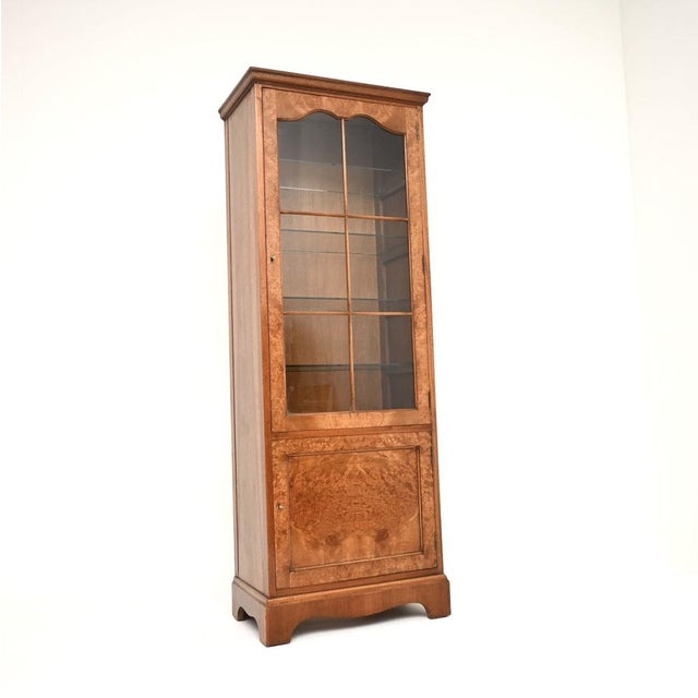 A lovely antique burr walnut bookcase in the Georgian style. This was made in England, it dates from around the 1930’s. It...