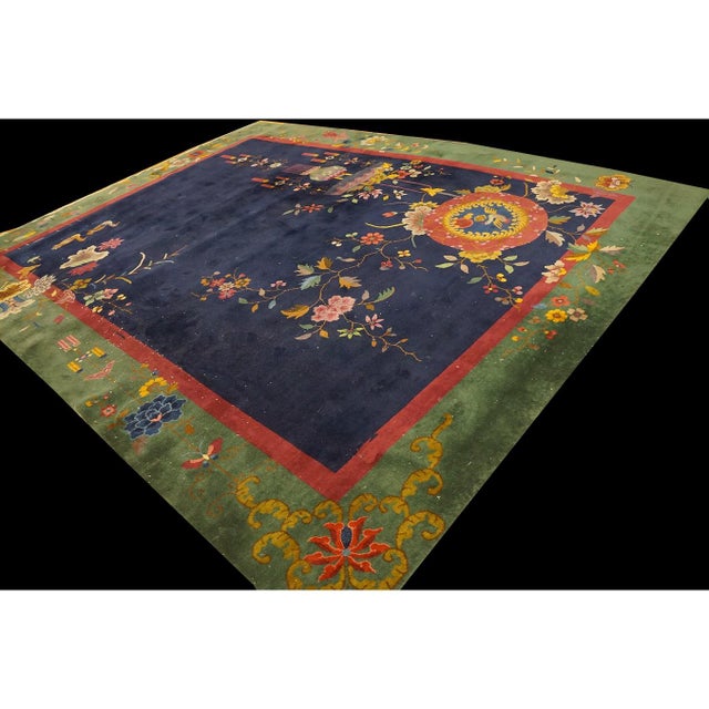 This exquisite 1920s antique Chinese Art Deco rug showcases a sophisticated blue palette, hand-knotted from premium wool....