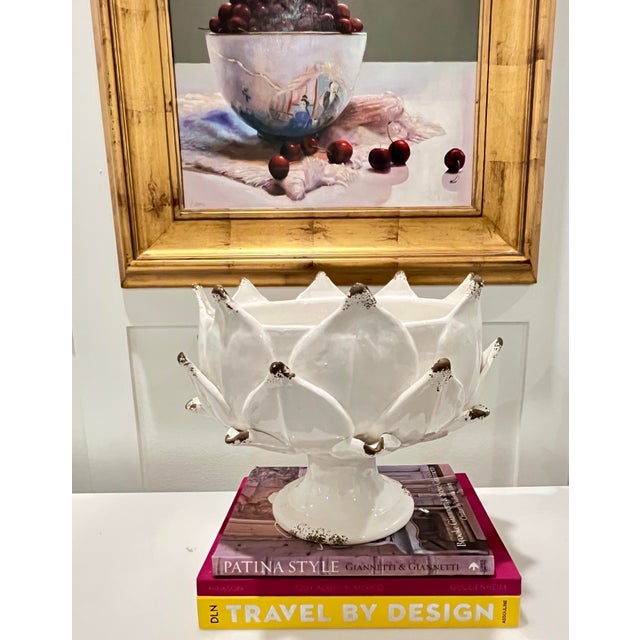This Italian hand-thrown majolica artichoke pedestal bowl in a versatile off white is a bold yet timeless decorative...