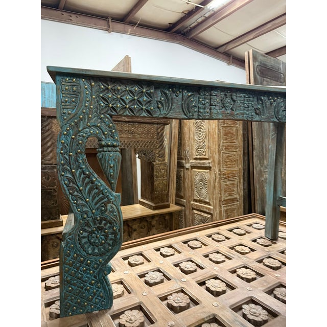 Elevate your entryway with this exquisite antique Indian console table, masterfully hand-carved with regal peacock motifs...
