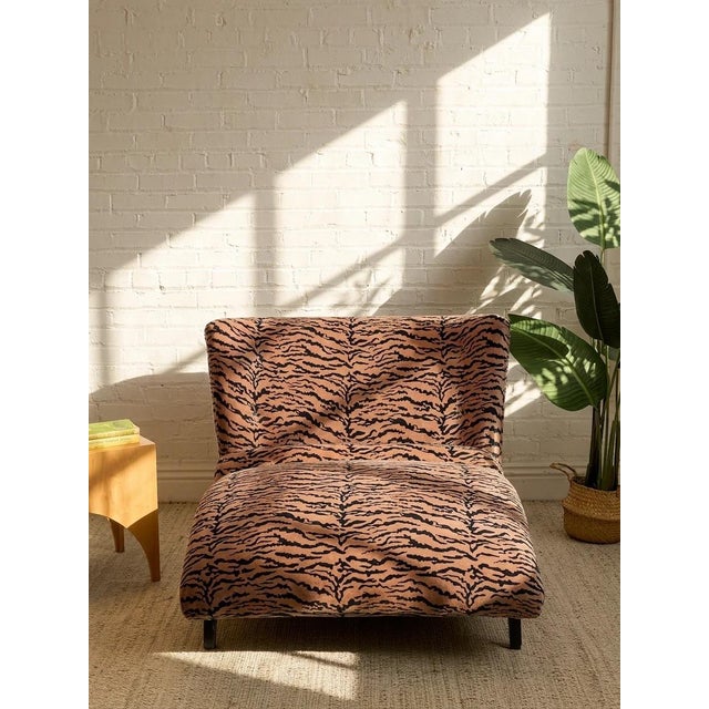 A fabulous 1950s chaise lounge with a dramatic low-slung silhouette, newly upholstered in bold blush and black tiger print...