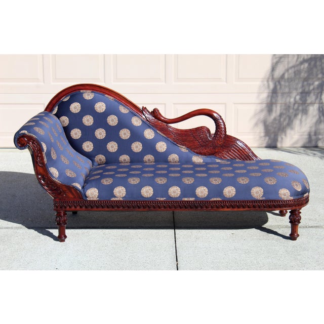 This striking Vintage Swan Sofa Chaise Lounge is a rare decorative seating piece featuring a hand-carved solid wood frame...
