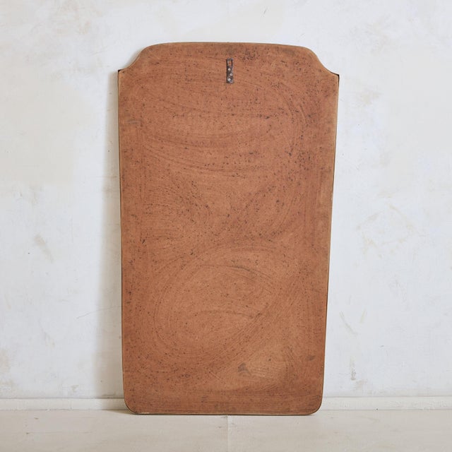 A large scale 1970s Italian wall or floor mirror featuring an elegantly curved top and subtly tapered silhouette. This...