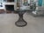 A hand-forged or wrought iron table featuring a thick 3/4-inch beveled glass top embodies the timeless, high-end artisan...