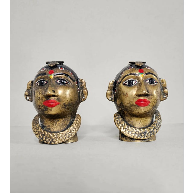 A pair of antique Indian hand-painted figural brass head religious sculptures. 19th century, Maharashtra or Karnataka...