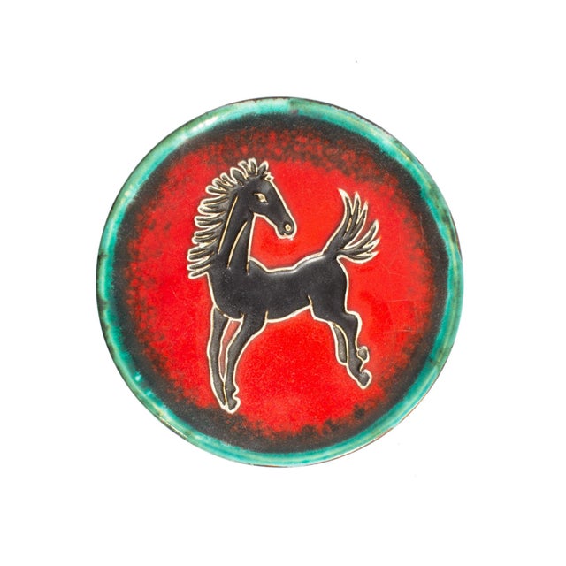 A West German ceramic box produced by Karlsruhe. This round box has a a dark green and black body and features a bright...