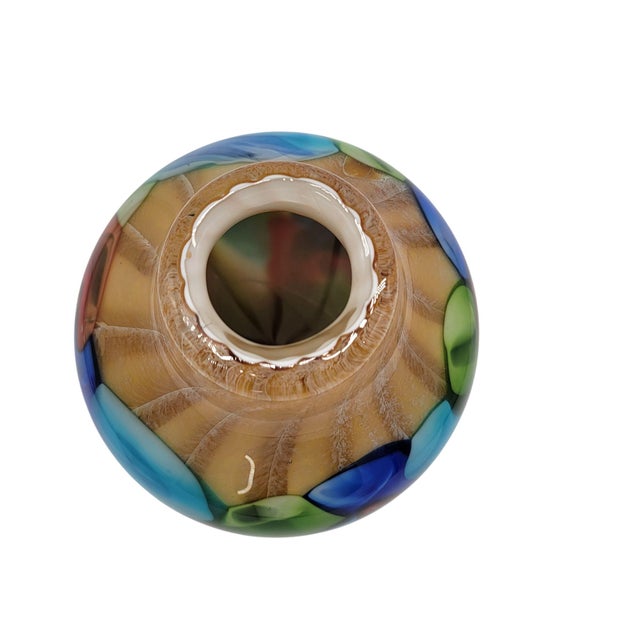 This vibrant handcrafted Murano glass vase showcases a stunning array of colors. Ideal as a unique decorative piece, it...