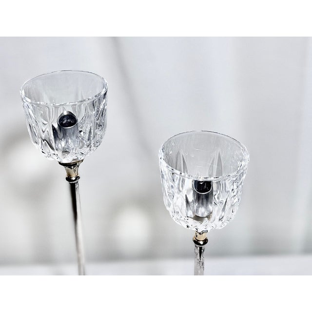 Elegant vintage candlestick holders crafted from silverplate over brass with clear pressed glass cup tops. Marked...