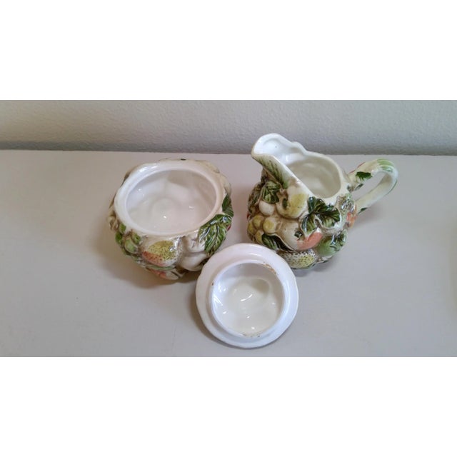 This Lefton Made in Japan sugar and creamer have many different fruits on them.