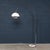 A striking italian arc floor lamp dating to the 1970s, showcasing the elegant, space-age aesthetic of the period. The...