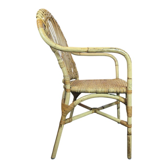 Vintage Mid-Century style rattan and wicker lounge chair. Brimming with bohemian texture and timeless character, this...