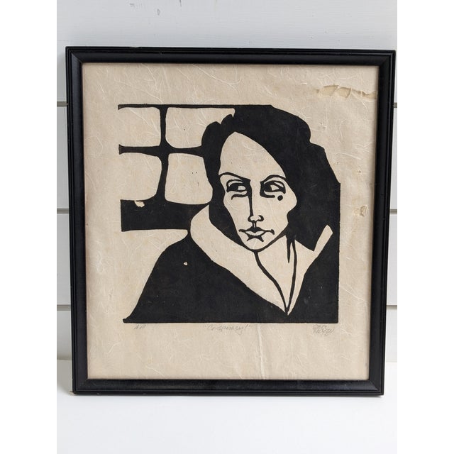 "Conspiracy" – 1972 Signed Woodblock Print, Framed This striking 1972 woodblock print titled "Conspiracy" captures the...