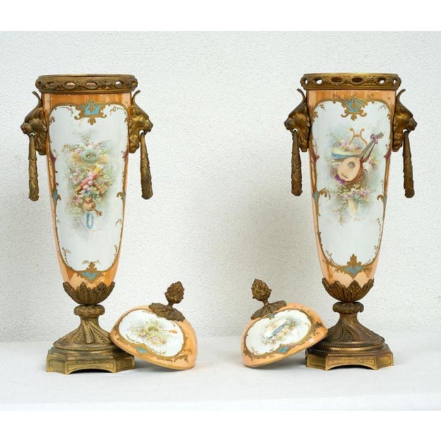 Pair of antique Napoleon III vases in polychrome Sevres porcelain. The front is characterized by a large medallion with a...