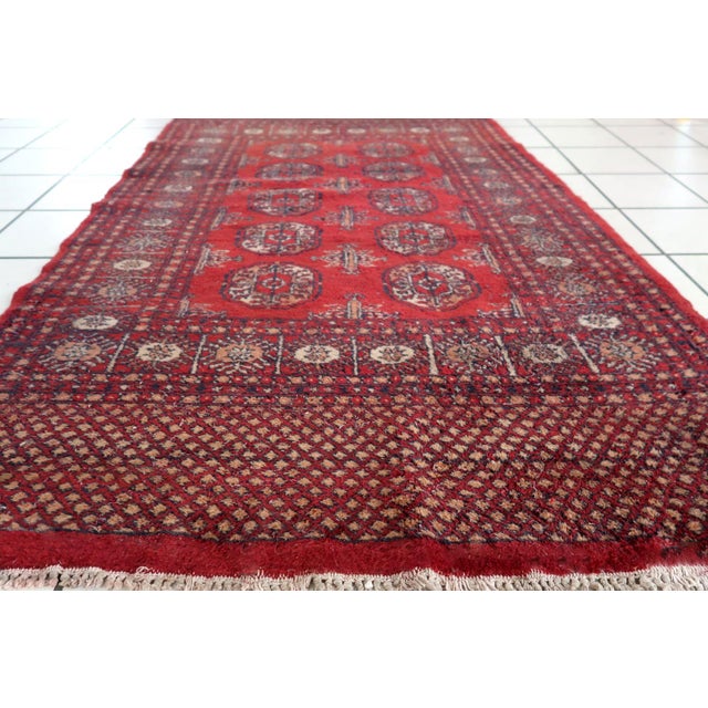 Handmade vintage Uzbek Bukhara rug in bright red color. The rug is from the end of 20th century in good condition, it has...