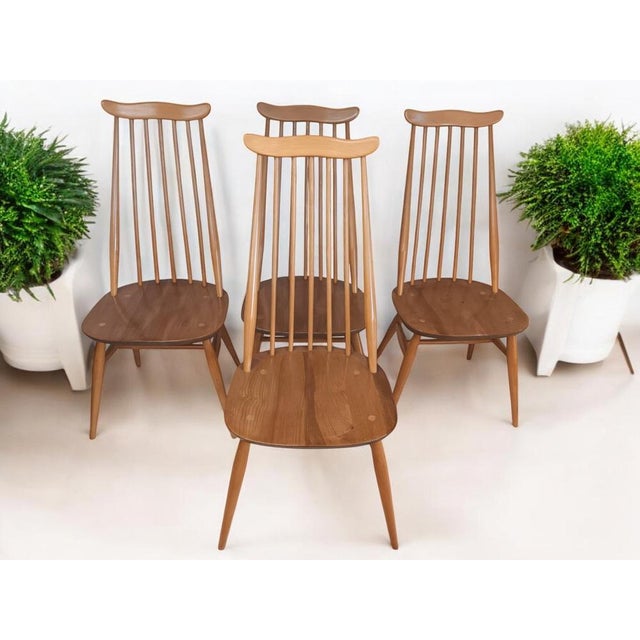 Introducing our exquisite vintage Set of 4 Ercol Goldsmith Dining Chairs in light Elm which consist of 4 x dining chairs....
